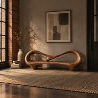 Bench with an open loop backrest and sculpted feet in an industrial loft entryway with exposed brick