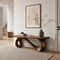 Bench with a plank seat on an s shaped scroll base in a Scandinavian entryway with white walls