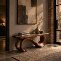 Bench with a plank seat on an s shaped scroll base in an industrial loft entryway with exposed brick