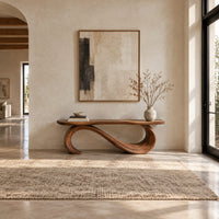 Bench with a plank seat on an s shaped scroll base in a bright open plan entryway