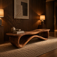 Low wood bench with a wavy slab top on an open ribbon loop base in an evening entryway with walnut wall paneling