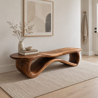 Low wood bench with a wavy slab top on an open ribbon loop base in a Scandinavian entryway with white walls