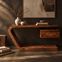 Corner detail of console table with a bent slab frame and a floating box under the top beside wood, brass and linen samples