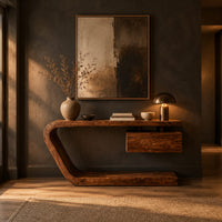 Console table with a bent slab frame and a floating box under the top in a dark entryway at golden hour