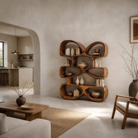 Bookshelf of stacked pebble shaped open cubbies with thick wooden walls in a bright open plan living room