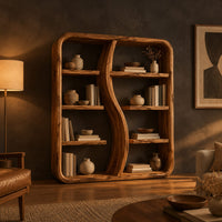 Bookshelf with a wavy s shaped divider and staggered shelves in a dark living room at golden hour