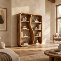 Bookshelf with a wavy s shaped divider and staggered shelves in a bright open plan living room