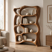 Tall bookshelf made of free form open cells with a sculpted outline in a Scandinavian living room with white walls