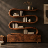 Corner detail of bookshelf made from one winding ribbon of wood above a low four panel base beside wood, brass and linen samples