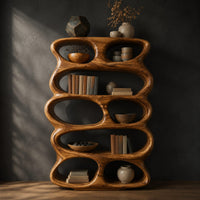 Tall sculpted bookshelf with stacked oval openings of mixed sizes, three-quarter view showing the grain