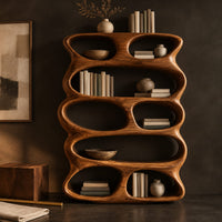 Corner detail of tall sculpted bookshelf with stacked oval openings of mixed sizes beside wood, brass and linen samples