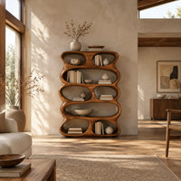 Tall sculpted bookshelf with stacked oval openings of mixed sizes in a bright open plan living room