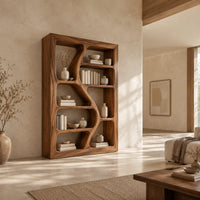 Freeform bookshelf with winding dividers and open cubbies in a thick frame in a bright open plan living room