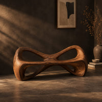 Bow tie bench with two large open loops and a thick smooth frame, three-quarter view showing the grain
