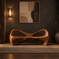 Bow tie bench with two large open loops and a thick smooth frame in a dark entryway at golden hour
