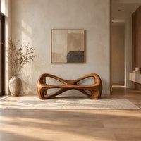 Bow tie bench with two large open loops and a thick smooth frame in a bright open plan entryway