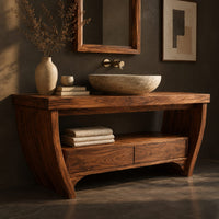 Corner detail of wooden bathroom vanity on bowed legs with an open lower shelf beside wood, brass and linen samples