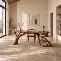 Desk with an arched branch leg and open shelf loops at one end in a bright open plan home office