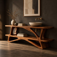 Bathroom vanity on a branching wood base with a plank top and low shelf, three-quarter view showing the grain
