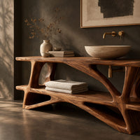 Corner detail of bathroom vanity on a branching wood base with a plank top and low shelf beside wood, brass and linen samples