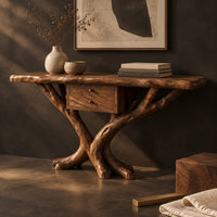 Corner detail of console table with a natural edge top, small drawer unit and crossed branch legs beside wood, brass and linen samples