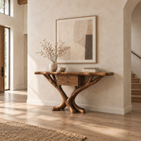 Console table with a natural edge top, small drawer unit and crossed branch legs in a bright open plan entryway