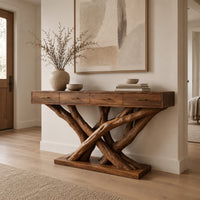 Console table with four slim drawers on a base of crossed tree branches in a Scandinavian entryway with white walls