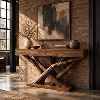 Console table with four slim drawers on a base of crossed tree branches in an industrial loft entryway with exposed brick