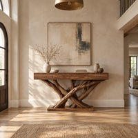 Console table with four slim drawers on a base of crossed tree branches in a bright open plan entryway