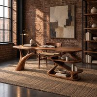 Writing desk with a branch shaped leg and stacked open shelves in an industrial loft home office with exposed brick