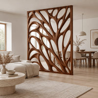 Tall room divider with sculpted open branch shaped cutouts in a Scandinavian open-plan living room with white walls