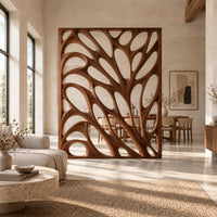 Tall room divider with sculpted open branch shaped cutouts in a bright open plan open-plan living room