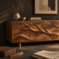 Corner detail of carved branch sideboard with four flush panels and short cylindrical feet beside wood, brass and linen samples
