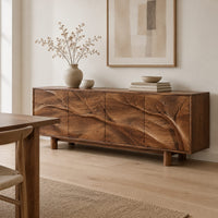 Carved branch sideboard with four flush panels and short cylindrical feet in a Scandinavian dining room with white walls