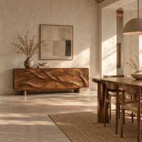 Carved branch sideboard with four flush panels and short cylindrical feet in a bright open plan dining room