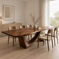 Dining table with a flowing slab top on a branching sculpted base in a Scandinavian dining room with white walls