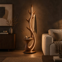 Branching floor lamp with a small shelf and a glowing trunk edge in a dark living room at golden hour