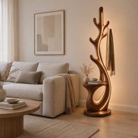 Branching floor lamp with a small shelf and a glowing trunk edge in a Scandinavian living room with white walls