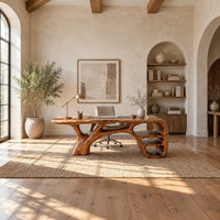Sculpted wooden desk with branching legs and open shelves at one end in a bright open plan home office