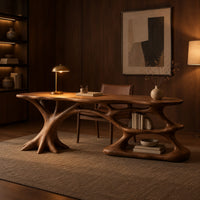 Desk with branching root base, freeform top and open lower shelf in an evening home office with walnut wall paneling