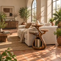 Tree shaped side table with three disc tops and an open base hollow in a bright living room with arched windows and plants
