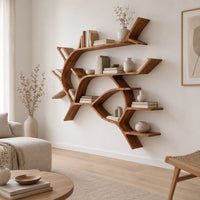Wall shelves shaped like a forking tree branch with many open levels in a Scandinavian living room with white walls