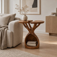 Side table with twin lobed tops on branching limbs above an open base in a Scandinavian living room with white walls