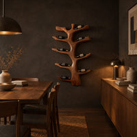 Branching tree wine rack with angled arms that cradle bottles in a dark dining room at golden hour