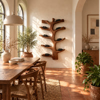 Branching tree wine rack with angled arms that cradle bottles in a bright dining room with arched windows and plants