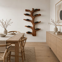 Branching tree wine rack with angled arms that cradle bottles in a Scandinavian dining room with white walls
