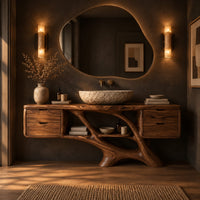 Bathroom vanity with a drawer block at each end and a branching trunk base in a dark bathroom at golden hour