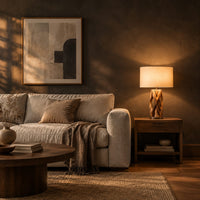 Branching wall sconce with open cutouts and a warm glow behind the wood in a dark living room at golden hour