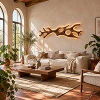 Branching wall sconce with open cutouts and a warm glow behind the wood in a bright living room with arched windows and plants