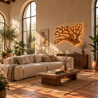 Branching wall sconce shaped like coral with a warm glow behind its edges in a bright living room with arched windows and plants